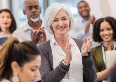 A group of people clapping 