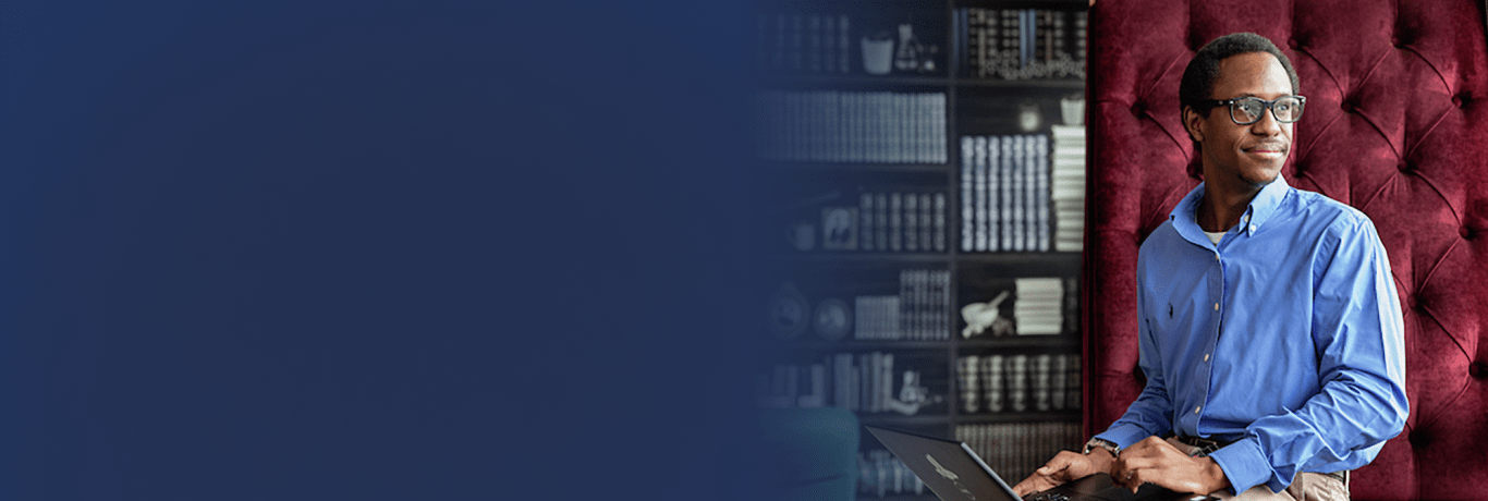 A man wearing glasses in front of a bookshelf