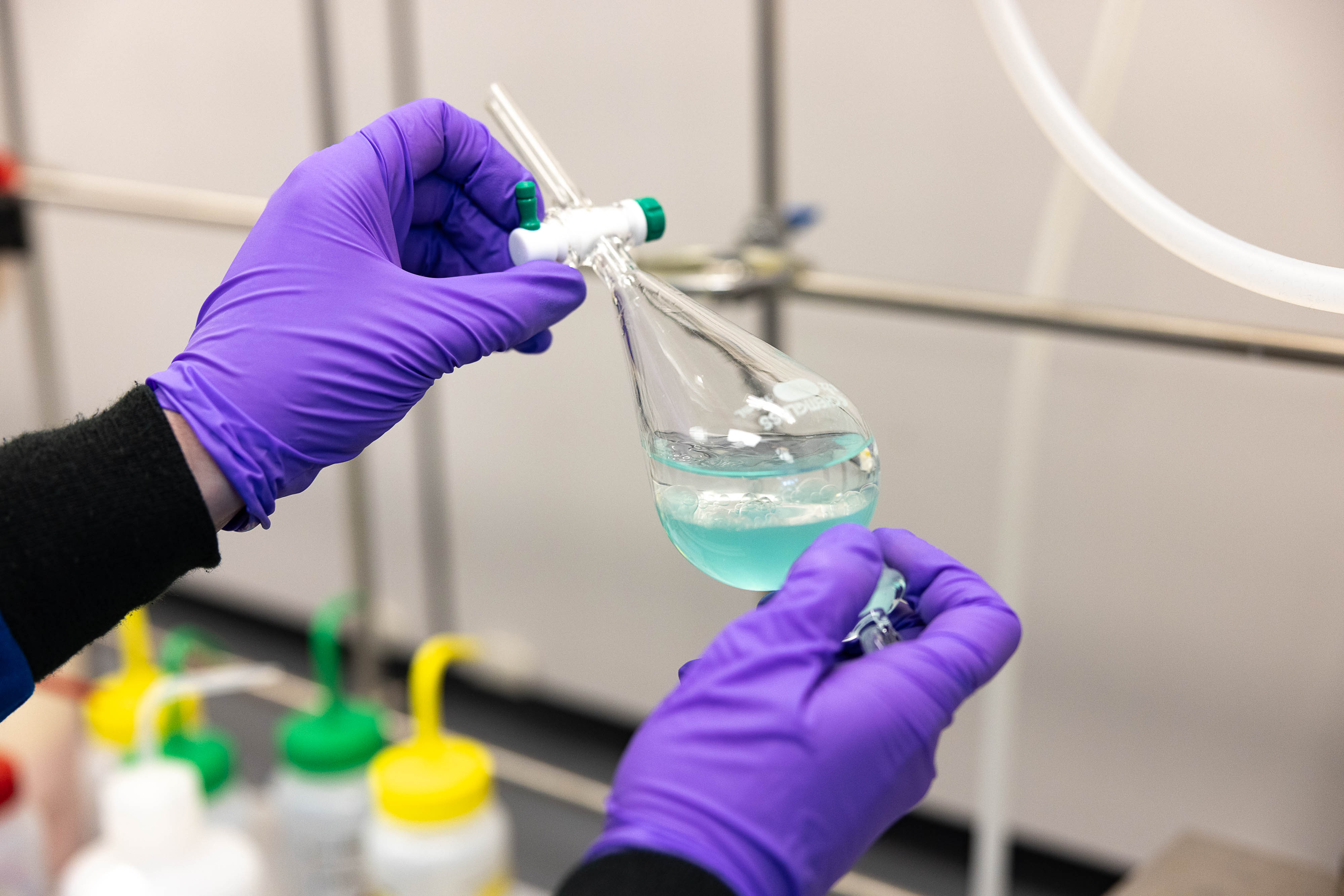 Sustainability-Focus-Areas-Woman-Lab-Coat-Pipetting