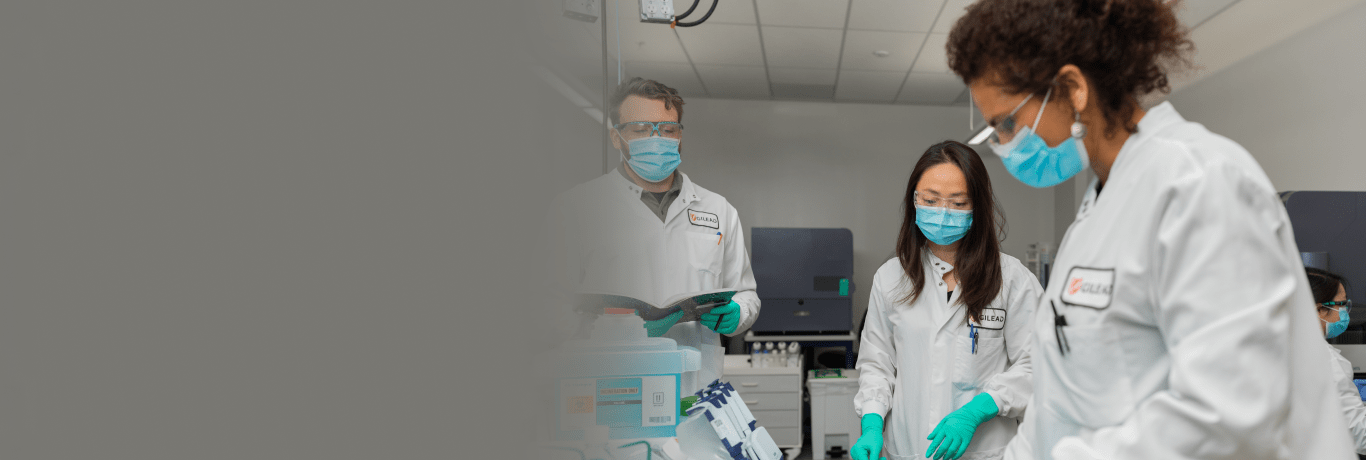 Three scientists working on a lab