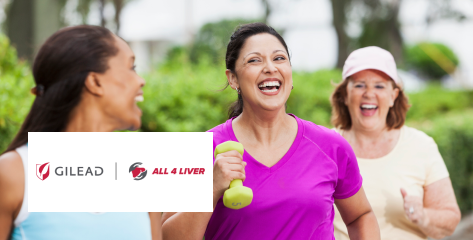 A group of women laughing while exercising outdoors.