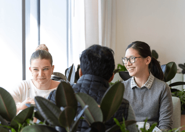 Four people sitting at the table and smiling