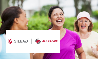 A group of women laughing while exercising outdoors.