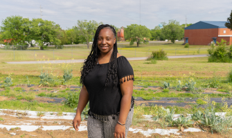Woman standing with African landscape in the background