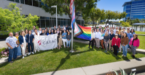 Large group of people outside Gilead during Pride flag raising