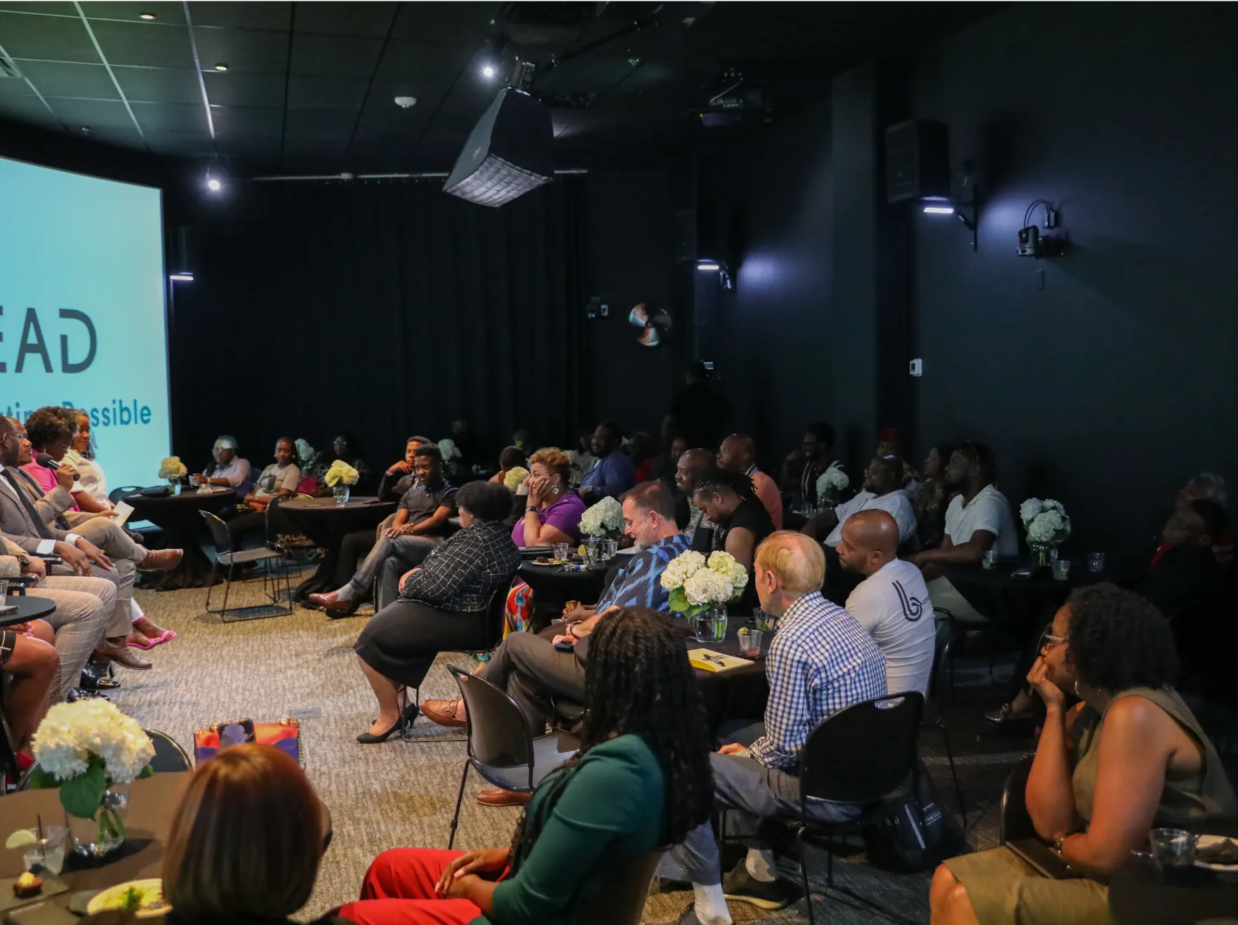 A group of people gathered in a small theater