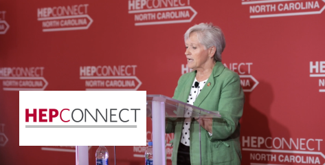 A woman speaking behind a podium with a HepConnect logo backdrop.